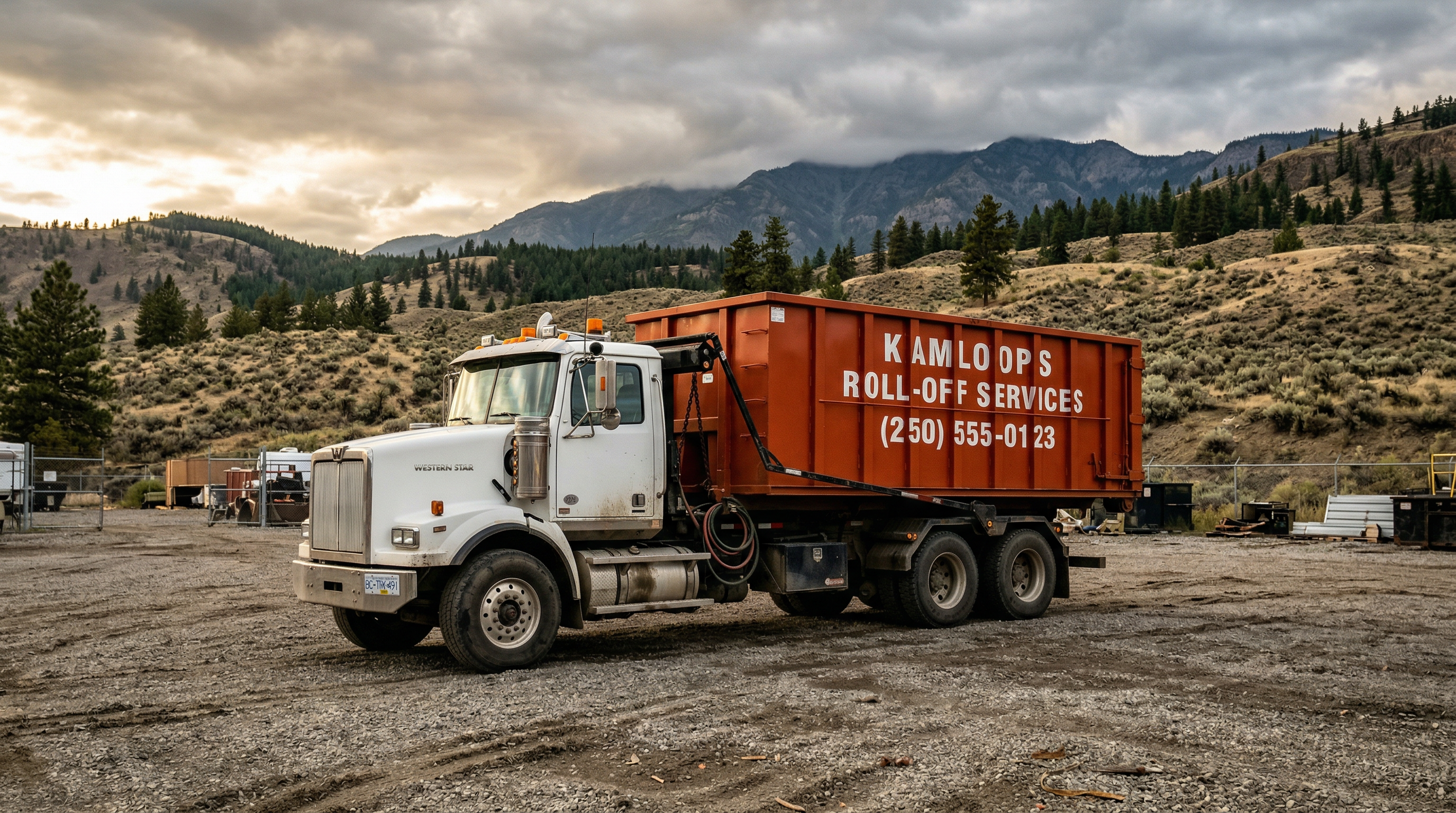 Interior Waste Solutions white truck with orange roll-off bin in BC mountains
